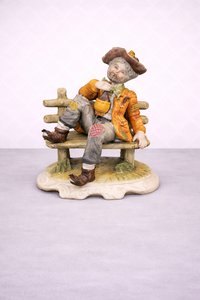 Porcelánová soška odpočívajúceho hudobníka