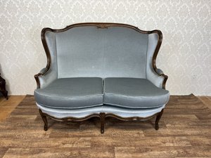 Elegantná sofa s krivkami a bohato zdobeným rámom